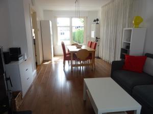 a living room with a table and a couch at Kustverhuur, Breskens, Nijverheidstraat 11 in Breskens