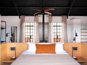 a bedroom with a large bed with a ceiling fan at Suidster in Montagu