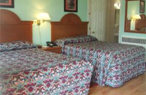 Postel nebo postele na pokoji v ubytování Robin Hood Motel