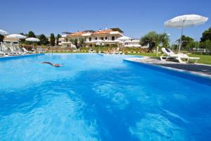 a person swimming in a large swimming pool at Homiday - Mykonos in Pineto