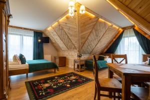 a living room with a bed and a table and a room at Kraina Smaku in Zakopane