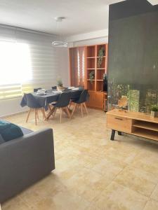 a living room with a table and chairs at UIM Mediterraneo PB Felipe 1 Wifi in Puerto de Sagunto