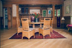 a dining room with a table and wicker chairs at Netherbrae in Edinburgh