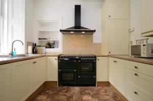 a kitchen with a black stove top oven at Bute View in Kames
