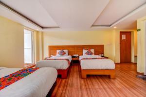 Postel nebo postele na pokoji v ubytování FabHotel Abirami Grand Inn - Nr Bryant Park