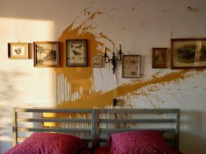 a bedroom with a wall covered in paint and pictures at StudioExtra incl auto P in Dordrecht