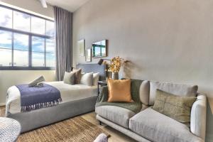 a living room with a couch and a couch at Gorgeous Designer Hideaway w/ Views at The Harri in Cape Town