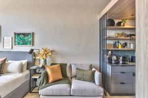 a living room with a couch and a chair at Gorgeous Designer Hideaway w/ Views at The Harri in Cape Town
