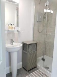 a bathroom with a sink and a shower at Stag Cottage in Ilkeston