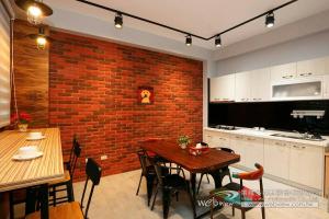 a kitchen and dining room with a brick wall at 蘭陽河畔居二館 in Yilan City