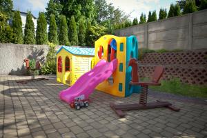 a playground with a slide and a chair at Pensjonat Pirat in Jastrzębia Góra