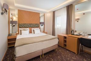 a hotel room with a bed and a desk at Marmara Hotel Budapest in Budapest