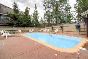 a large swimming pool with chairs and a fence at Ski Hill 32 in Breckenridge