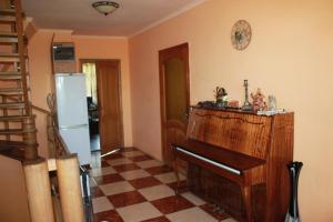 a living room with a piano and a refrigerator at Hostel Teremok in Kyiv