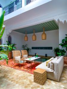 a living room with a couch and chairs and a table at Riad Danka in Marrakesh