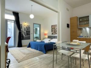 a living room with a bed and a dining table at Euphorbia Residence in Lecce