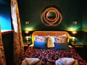 a bedroom with a bed with a mirror on the wall at Drumdelgie Cottages in Huntly