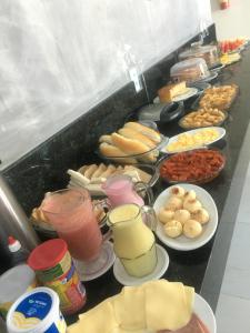 a buffet filled with different types of food on plates at Serra Village Hotel in Ubajara
