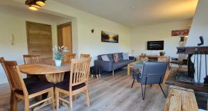 a living room with a table and a couch at Haus Jonghof in Seefeld in Tirol