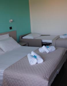 Postel nebo postele na pokoji v ubytování Hotel Palazzo Caveja