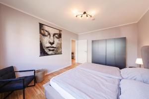 a bedroom with a bed and a painting on the wall at Kambrium in Münster +4 photos