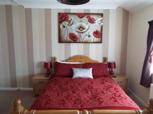 A bed or beds in a room at Guston Guest House 
