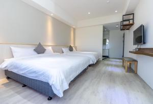 Llit o llits en una habitació de 后棧Hou Inn