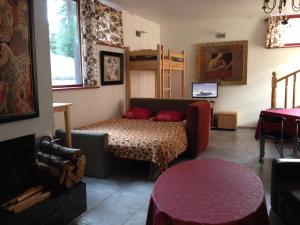 a living room with a couch and a table at Apartments Melnalkšņi in Saulkrasti