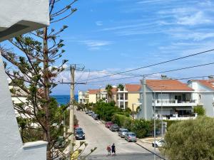 a view of a street with houses and the ocean at Penélope Hotel in Ialysos