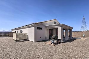 a small white building in a gravel parking lot at Luxe Home with OHV Access, 5 Mi to Lake Mohave! in Bullhead City