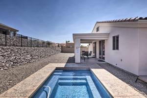 a swimming pool in front of a house at Luxe Home with OHV Access, 5 Mi to Lake Mohave! in Bullhead City