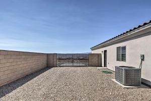 a building with a gate and a fence at Luxe Home with OHV Access, 5 Mi to Lake Mohave! in Bullhead City