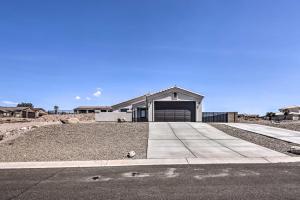 a house with a driveway and a garage at Luxe Home with OHV Access, 5 Mi to Lake Mohave! in Bullhead City
