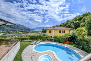 a backyard with a swimming pool and a house at Villa Caterina in Salò