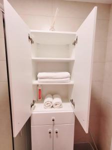 a small bathroom with white shelves and towels at Good Vibes :) in Juodkrantė +26 photos