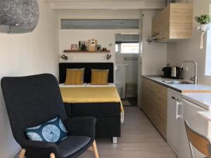 een kleine keuken met een tafel en een stoel bij De Zwarte Ruiter in Callantsoog