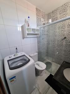 a bathroom with a toilet and a sink and a shower at cobertura jangadeiro RUA JANGADEIROS 215 in Maragogi +10 photos