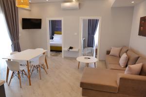 a living room with a couch and a table at Blue Water Hotel Ksamil in Ksamil