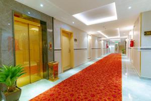 a hallway with a red carpet in a building at ريـزورد بـلازا - RIZORD plaza in Hafr Al Baten