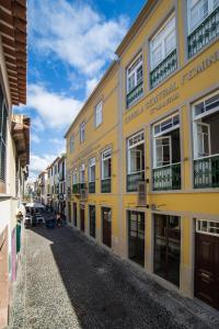 a yellow building on the side of a street at Santa Maria Hostel in Funchal
