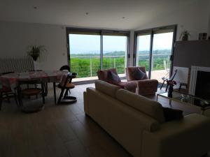 a living room with a couch and a table at villa Bouillat d'Anty in Châtel-Guyon