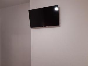 a flat screen tv hanging on a wall at Hotel Azahar in Oliva