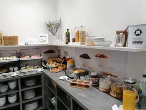 
a kitchen counter filled with lots of food at Hotel Hanseat Stralsund in Stralsund
