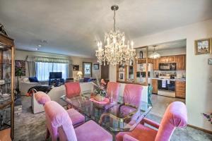 a living room with a glass table and pink chairs at Harrisburg Home with Deck 12 Mi to Hersheypark in Harrisburg