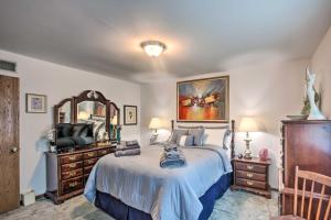 a bedroom with a bed and a mirror and a television at Harrisburg Home with Deck 12 Mi to Hersheypark in Harrisburg