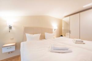 Postel nebo postele na pokoji v ubytování Haus am Meer Wintergarten PH 7, 2 SZ, strandnah by Unsere Urlaubszeit