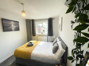 a bedroom with a bed and a window at Canterbury Modern 6 Bedroom House with Hot Tub in Canterbury