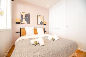 a bedroom with a large bed with two pillows at MBM - LOFT MARAIS in Paris