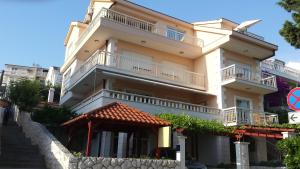 a large white building with balconies on it at Apartments Jani in Hvar