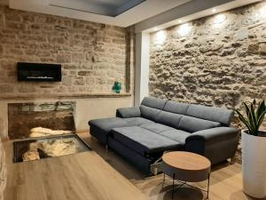 sala de estar con sofá y chimenea en Appartamento Gattapone 9, en Gubbio